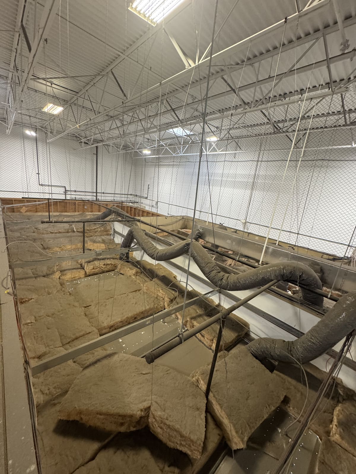 Commercial interior with the floor opened and ductwork exposed