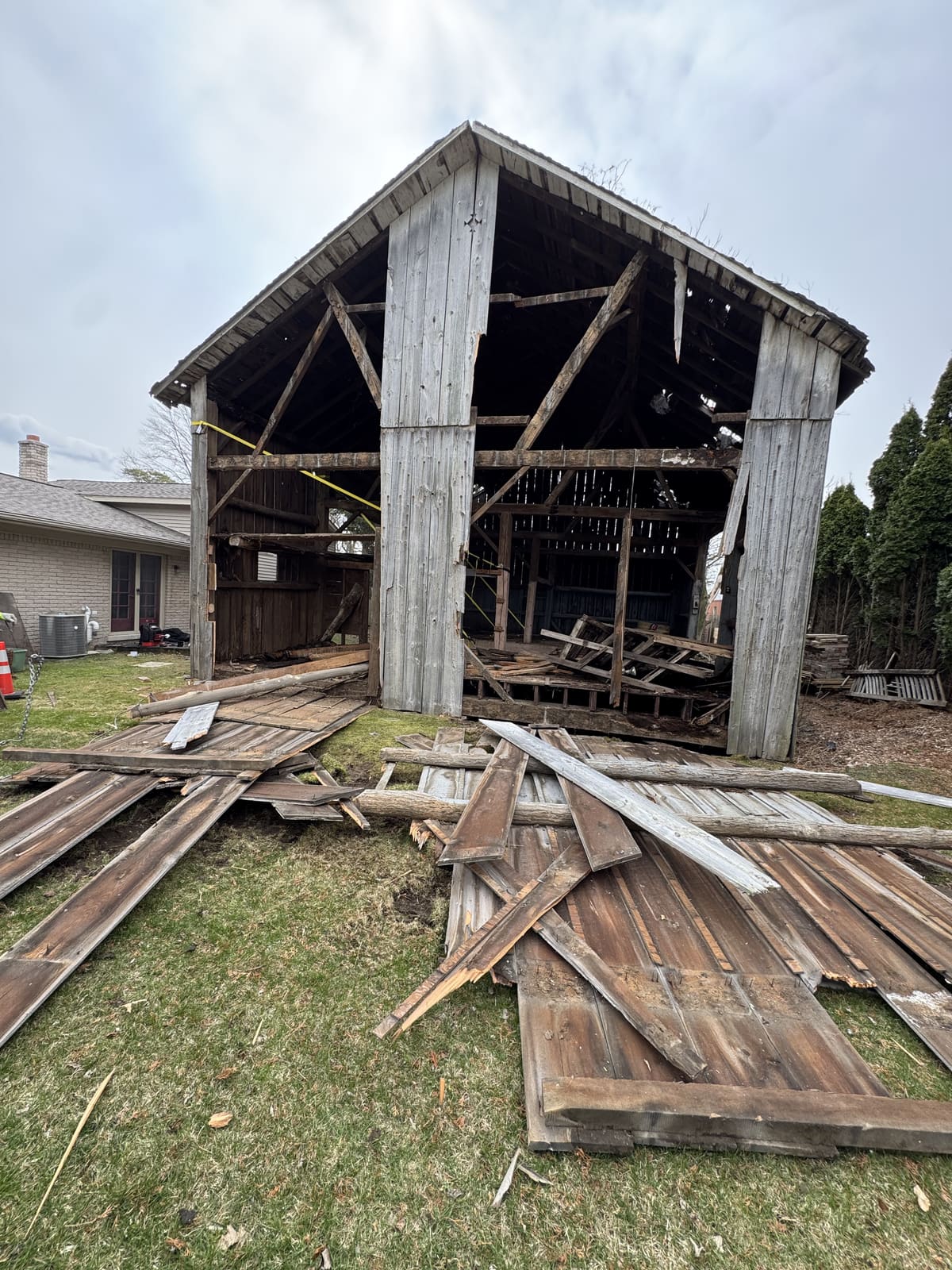 Wood outbuilding with the roof and walls coming down