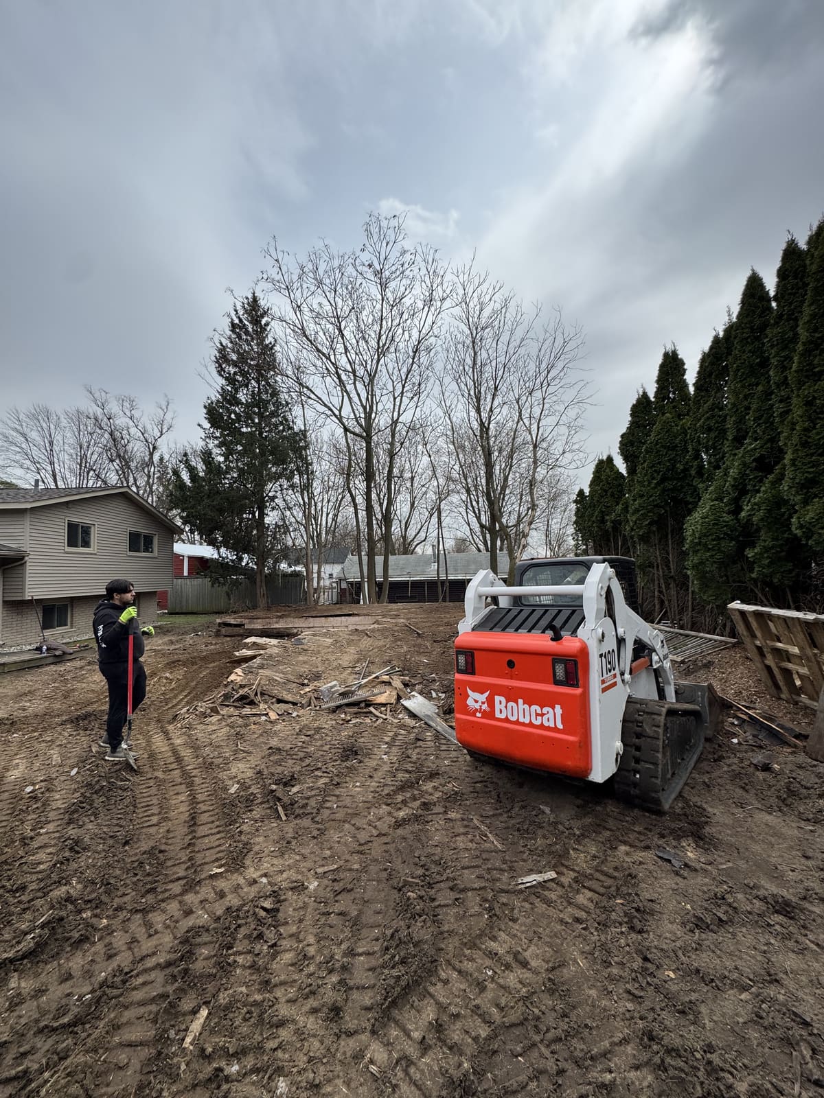 Bobcat on a cleared lot after a building demolition