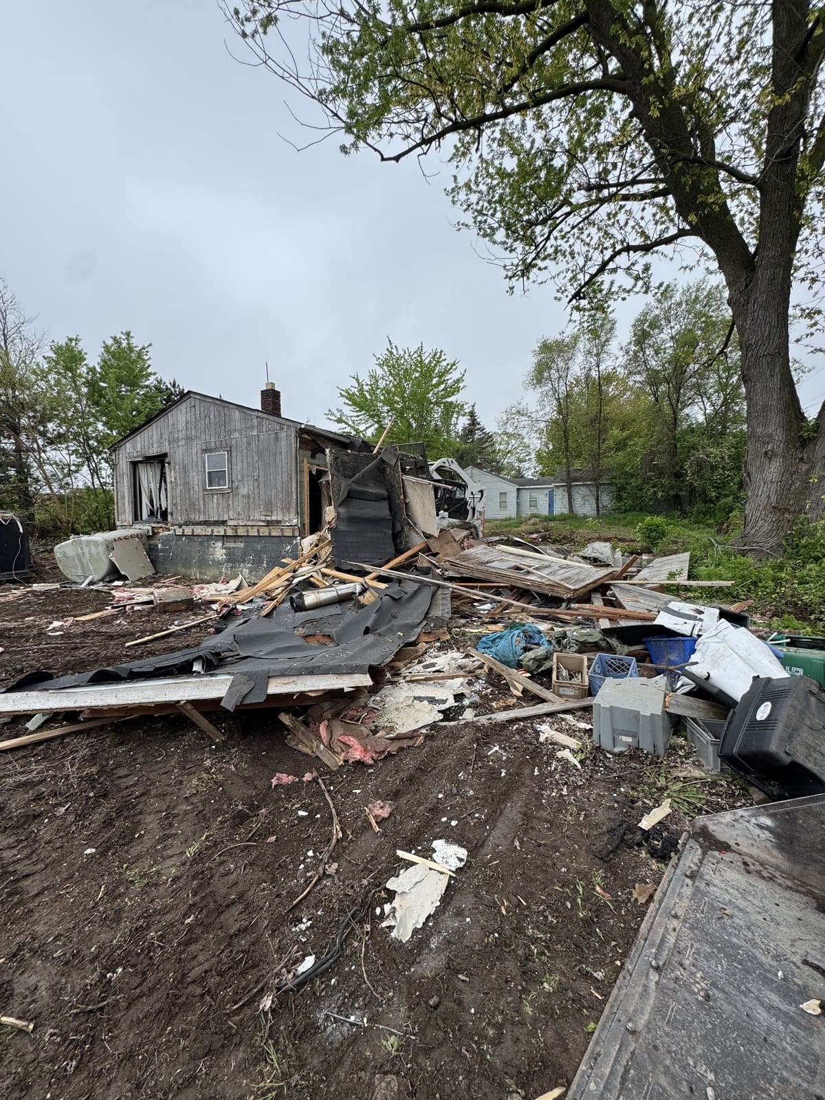Collapsed shed with the roof and walls on the ground