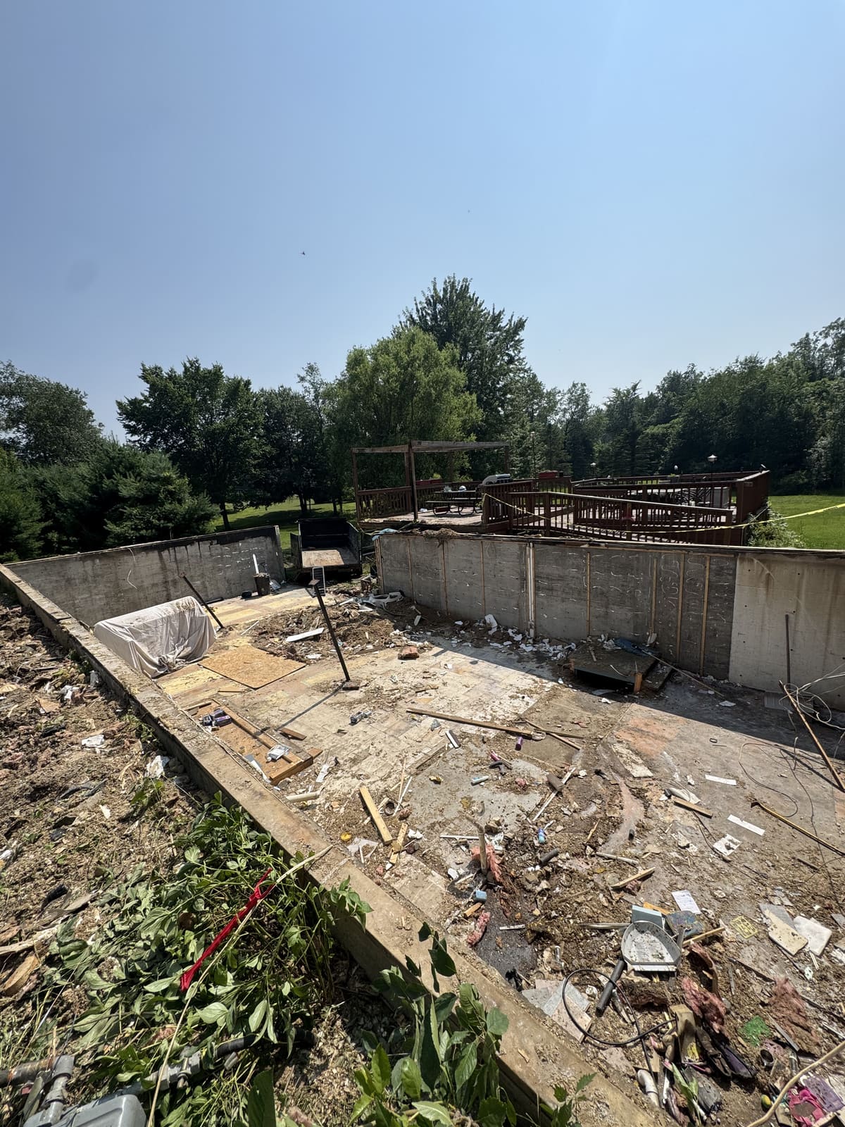 Concrete foundation walls left after the structure above was removed